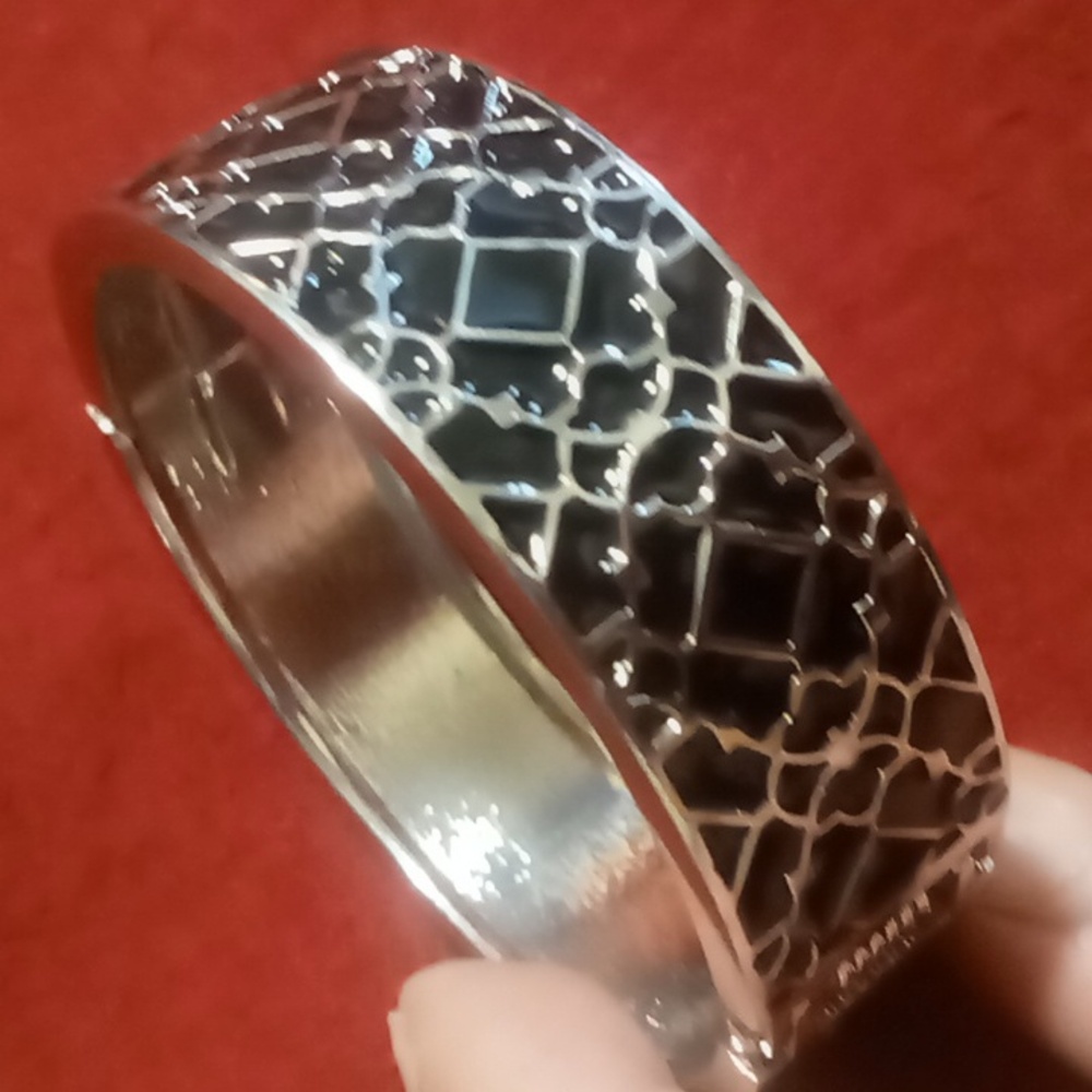 Black & silver tone clamper  bracelet Four leaf design. Spring Hinged .